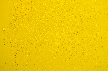 Rain water droplets on yellow cover background. Water droplets and wallpaper concept.