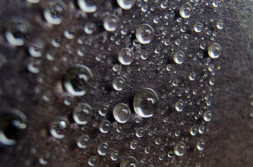 Close up or macro photography of water droplets on dark cover cover background. Water droplets and wallpaper concept