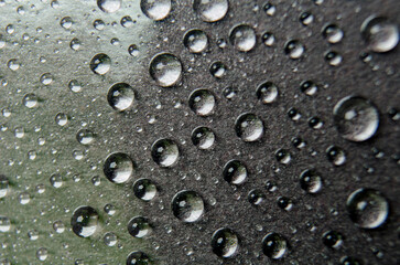 Focus on water droplets on dark cover suitable for wallpaper concept.