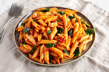 Homemade One-Pot Spinach And Tomato Pasta on a Plate, side view.