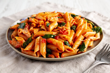Homemade One-Pot Spinach And Tomato Pasta on a Plate, side view.