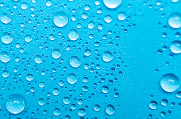 Close up of water droplets on blue cover background. Water droplets concept