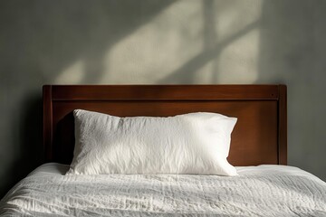 An unmade bed with a single pillow left undisturbed, loss, the absence of companionship