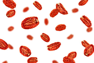 Falling dried Tomato isolated on white background, selective focus