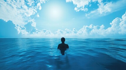 A person floating in a calm ocean, staring up at the blue sky with a sense of peace and wonder at the world.