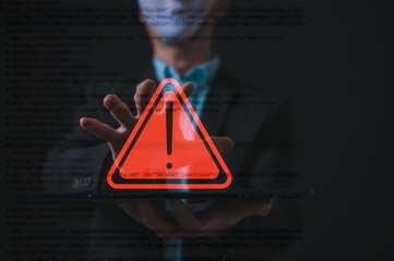 Risk and business data protection Businessman wearing mask pointing at triangle warning sign with blurred data charts background