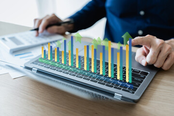 Businessman working with growth chart of financial and banking, revenue and income or wealth and profit. Success idea of business strategy and planning in investment and target achievement concept.