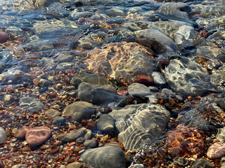 Stones  pebbles in transparent river water.