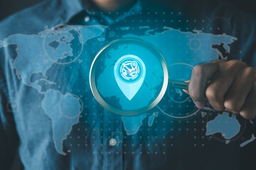 Businessman using magnifier for logistics with map and logistics icons and supply chain management.