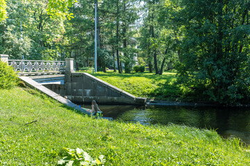 A bridge over a river with a person sitting on a raft