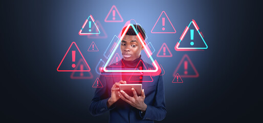 Man holding tablet with floating warning icons on blue backgroun