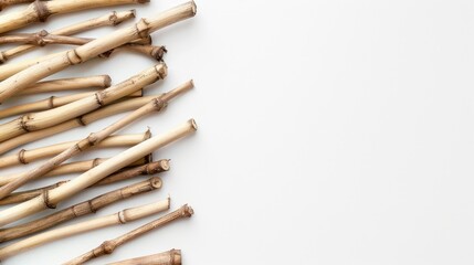 Fototapeta premium Top view of bamboo sticks arranged on white background with text space