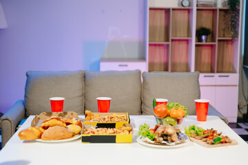 Mouth watering pizza, roasted chicken, fresh fruits, and drinks on a table. Perfect for food celebrations, gatherings,