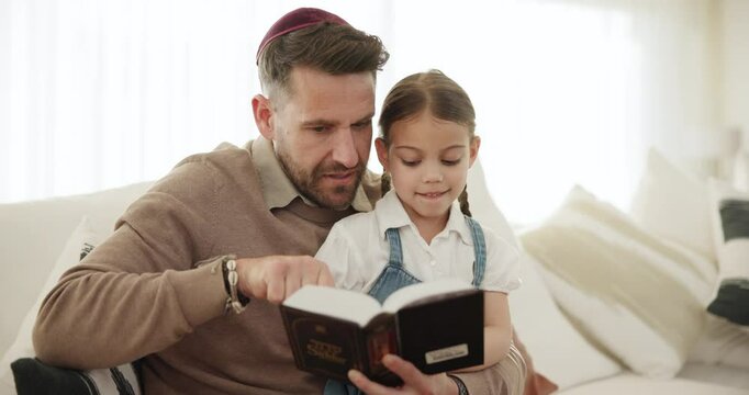 Reading, book and father with girl in home, teaching and learning about Torah, religion and spiritual knowledge. Child, education and sharing Jewish faith, history and culture on sofa together