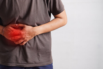 Fitness, stomach ache and man outdoor after running, workout or exercise. Sports, abdominal pain...