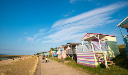Holiday wooden beach huts facing the ocean on the beach of Whitstable Kent England.