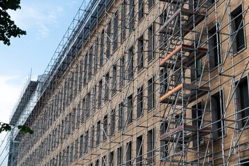Scaffolding covering modern building under construction © Michalis Palis