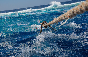 Mooring with a thick rope to the Big Brother island of a diving yacht during a storm