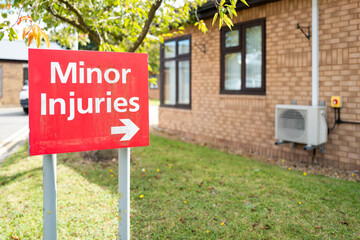 Shallow focus of a Minor Injuries medical and emergency sign seen outside a typical NHS hospital....