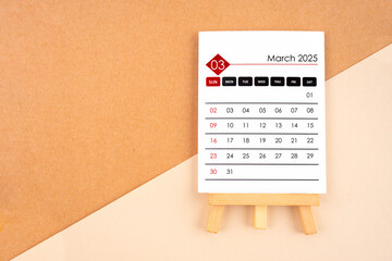 2025 March calendar page on brown background.