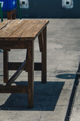 
Empty wooden benches in the hot sun created a shadow, no one dared to sit there alone