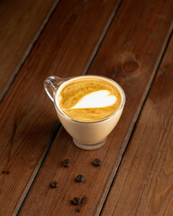 cup of cappuccino on wooden table