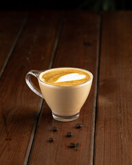cup of cappuccino on wooden table 