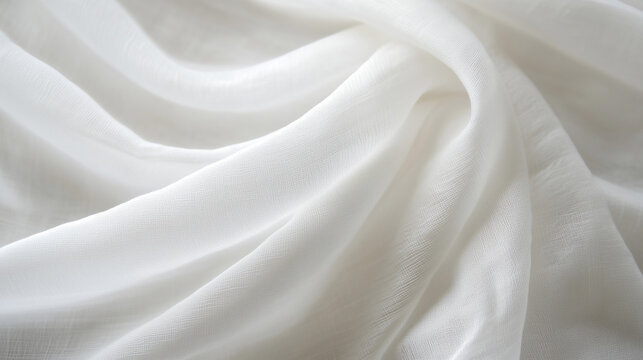 A close-up of the texture and quality of white linen fabric, focusing on its softness. The fabric is flowing in gentle waves with subtle folds that give it an elegant appearance.
