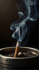 Close-Up of a Lit Cigarette Resting in a Glass Ashtray with Rising Smoke