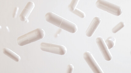 White capsules spread out in the air on black background