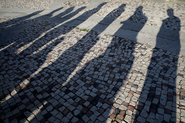 Morning shadows of people in the street