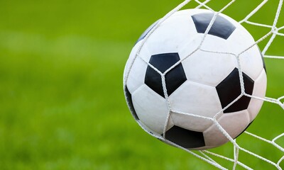 occer Ball in Net on Green Field - Goal Success Sports Background