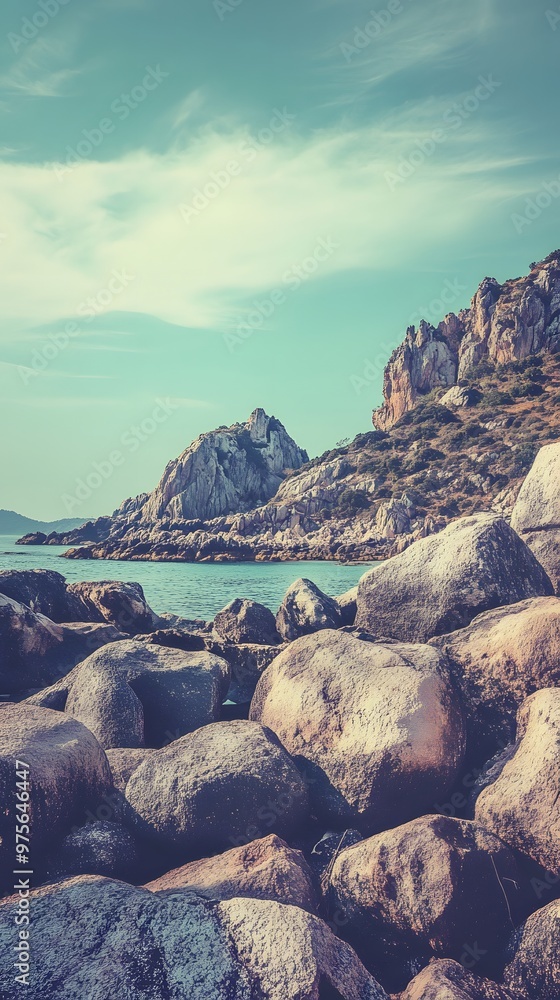 Canvas Prints Rocky shoreline with blue water and a mountain backdrop.