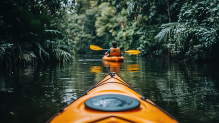 Fototapeta premium A person kayaking on tranquil river surrounded by lush greenery