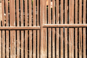 Old wooden garden fence door detail closeup as wooden background