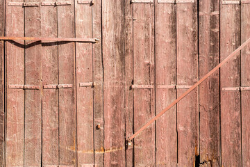 Fototapeta premium Old wooden garden fence door detail closeup as wooden background