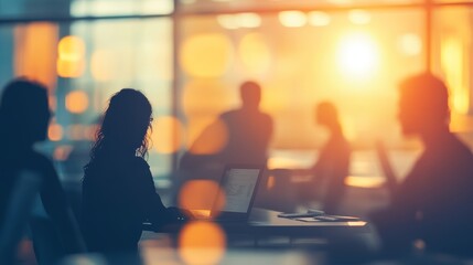 Silhouettes of diverse people collaborating in a blurred coworking space for teamwork
