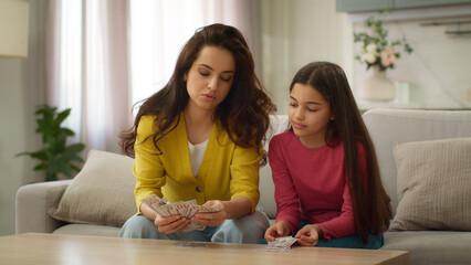 Happy family loving Caucasian woman mother female mom counting dollars cash dollar bill saving...