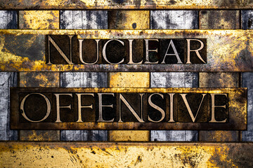 Nuclear Offensive text in real authentic typeset letters on vintage textured silver grunge copper and gold background
