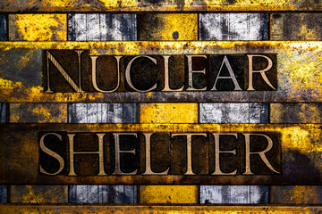 Nuclear Shelter text in real authentic typeset letters on vintage textured silver grunge copper and gold background