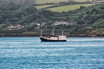 Obraz premium Fishing Boat on Calm Waters in Penzance, Cornwall, UK