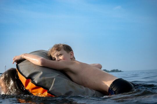 Children have fun playing in the water while floating on a tube.
