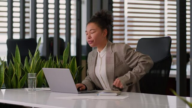 Sedentary work office African American woman girl businesswoman female business worker computer at desk feel pain suffer discomfort back ache health problem backache unwell disease arthritis overwork