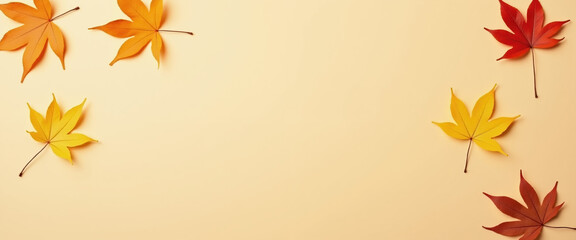 Autumn leaves background, minimalistic yellow red leaf border on beige cream background, copy space.  Fall greeting background.