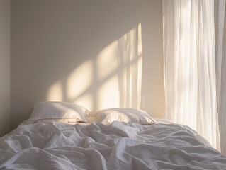 Cozy morning light cascades on rumpled bed linens in a peaceful bedroom setting