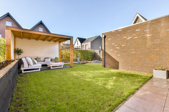 Modern backyard with cozy patio and lush lawn