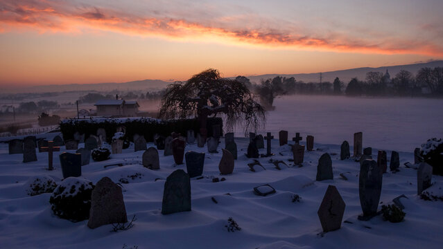 Snow-covered cemetery at sunset in Morges, Switzerland