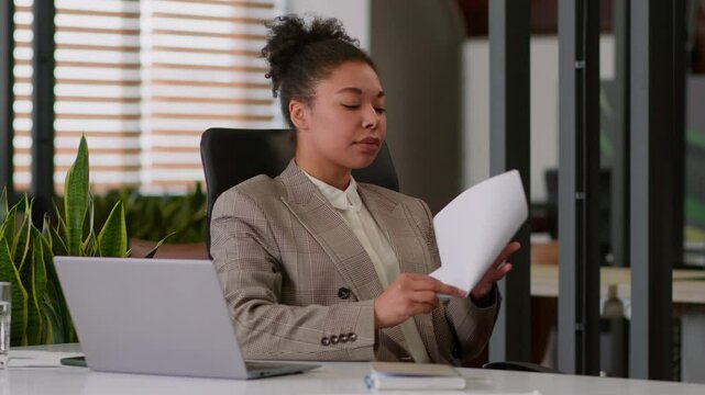 African American woman female boss office agent read document financial report business girl crumple sheet of paper throw away serious dissatisfied businesswoman HR manager employer crumpling notes