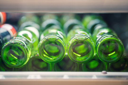 Green glass bottles stacked in close-up view