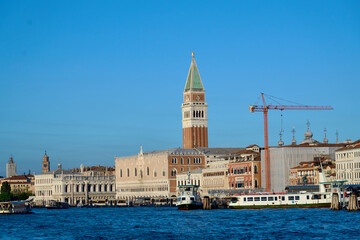 grand canal at sunset with the tower of piazza San Marco and boat in first plane